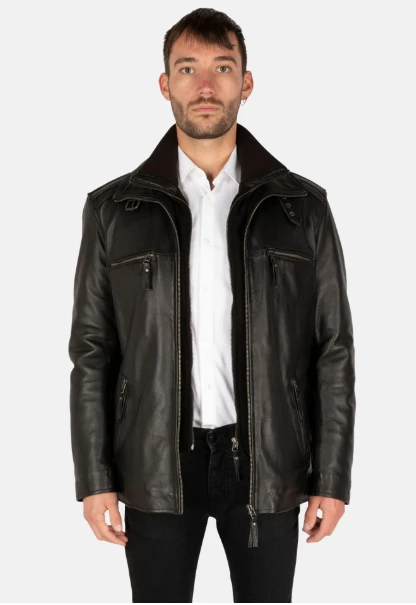 Cycas d'Or model wearing the Flex Black Coat Leather and posing on a white background. 